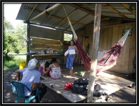 GSWC peer educator with a mother and her children GSWC peer educator with a mother and her children